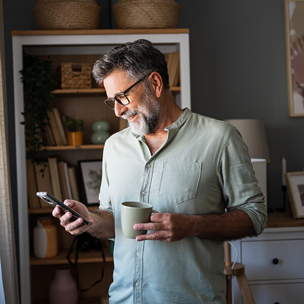 Woman smiling and checking credit score on her phone