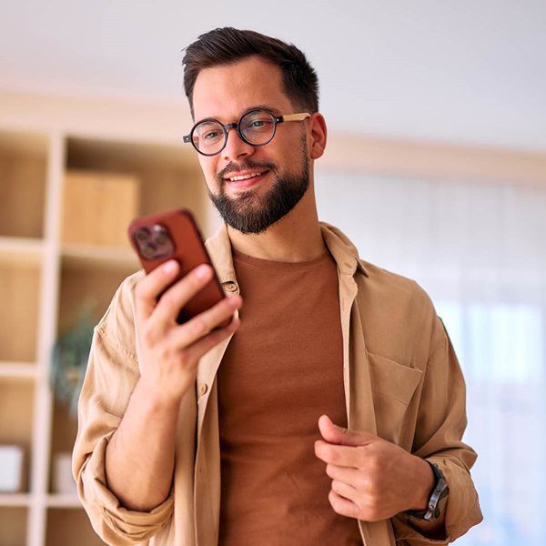 Man looking at phone and smiling