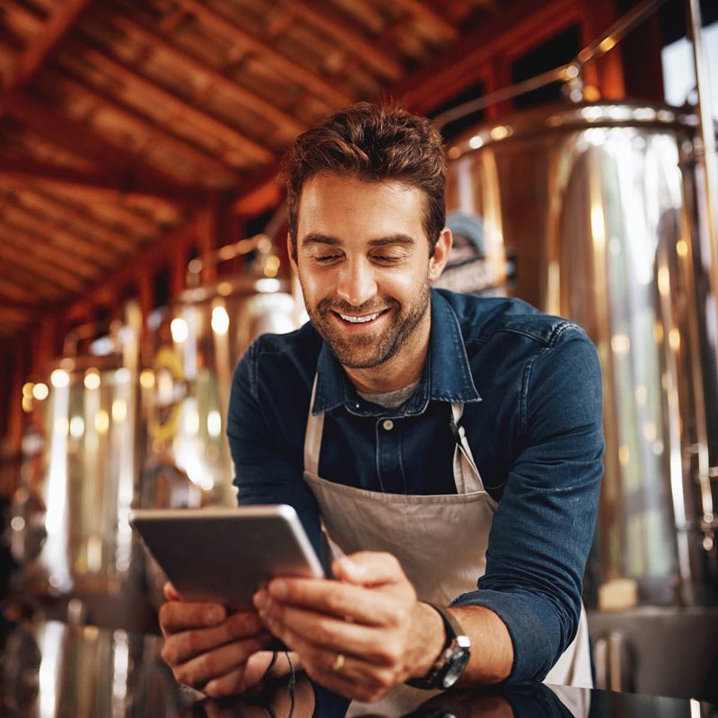 Man looking at tablet in brewery